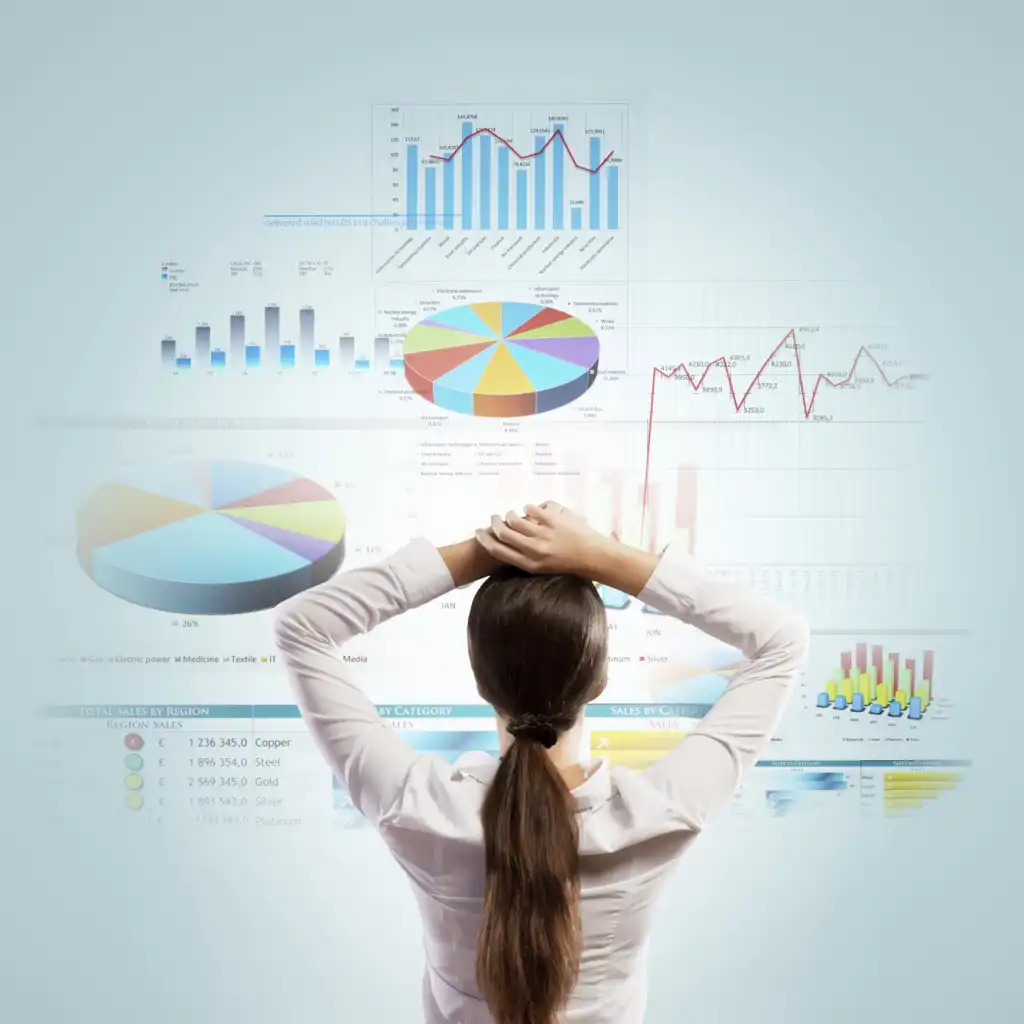 woman standing in front of data chart wall