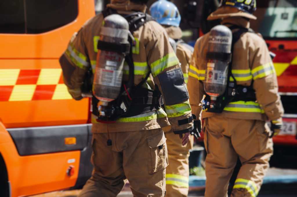 Group of South Korean fire men during fire fighting operation in the streets, firefighters with fire engine truck vehicle, 911 emergency and rescue
